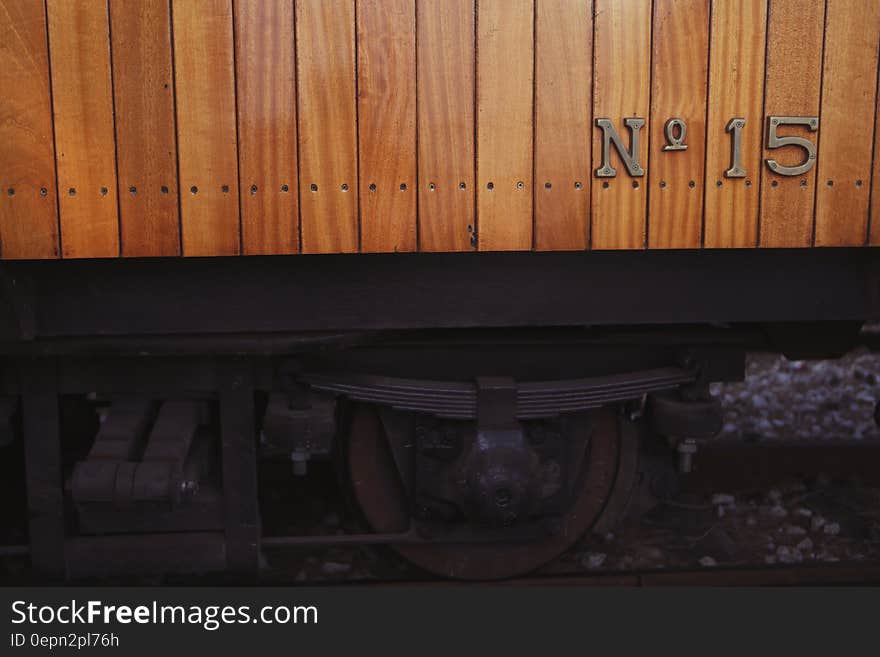 Railway wagon or carriage constructed of polished wood and bearing label No 15. Springs, wheels and track visible below. Railway wagon or carriage constructed of polished wood and bearing label No 15. Springs, wheels and track visible below.