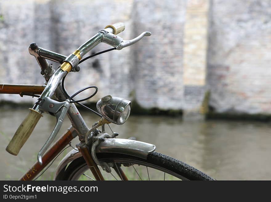 Frontal part of a bicycle parked in a street. Frontal part of a bicycle parked in a street.