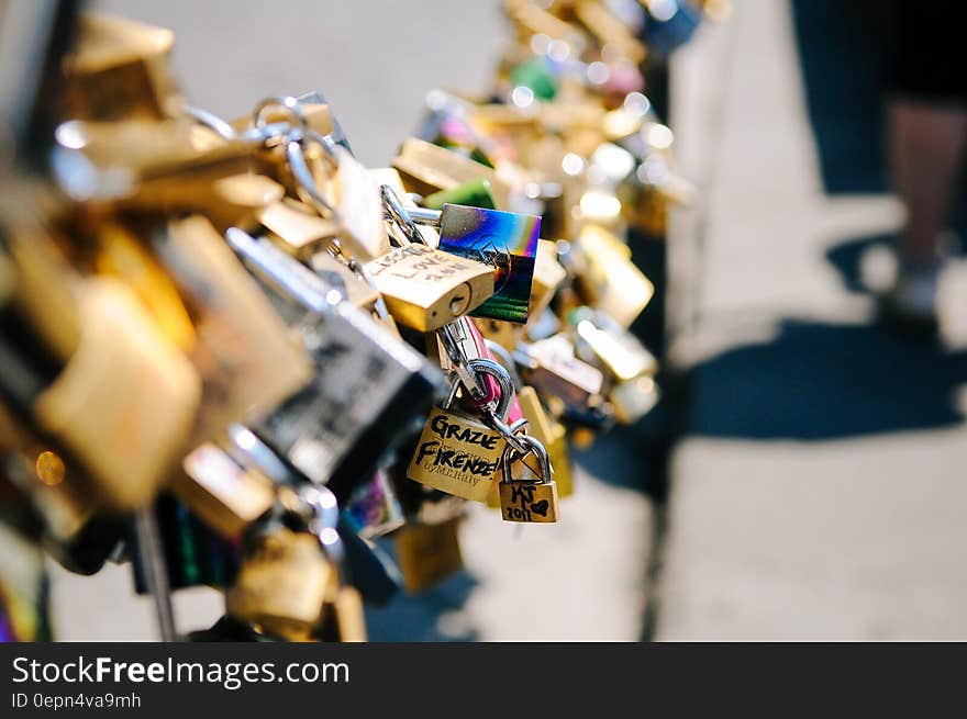 Locks of love on urban bridge on sunny day.