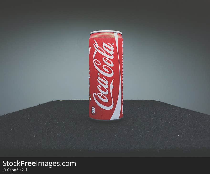 Can of Coca-Cola on table.