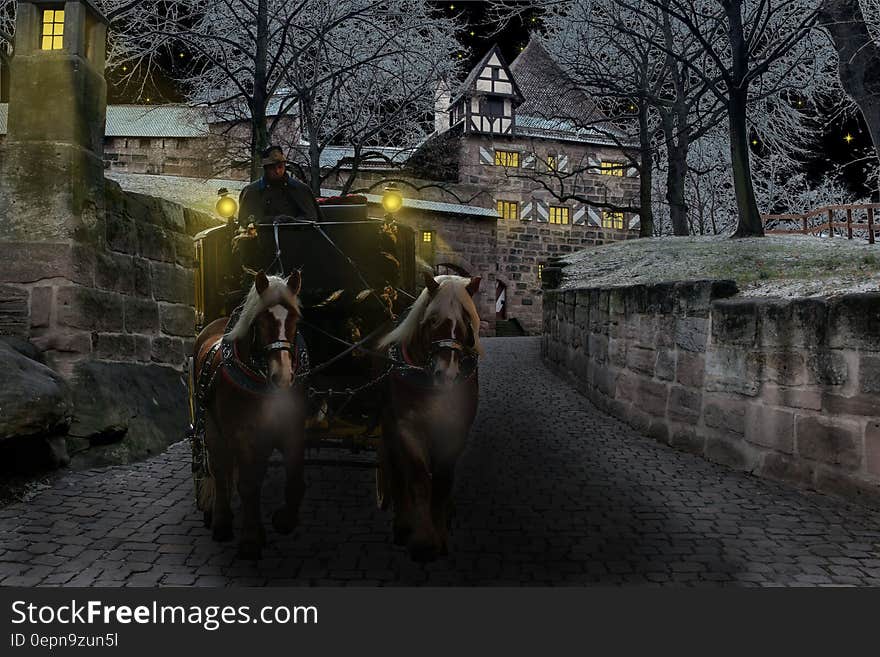 A horse-drawn coach on a cobblestone street. A horse-drawn coach on a cobblestone street.