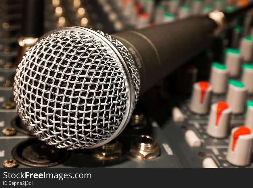 A microphone on a mixing table. A microphone on a mixing table.