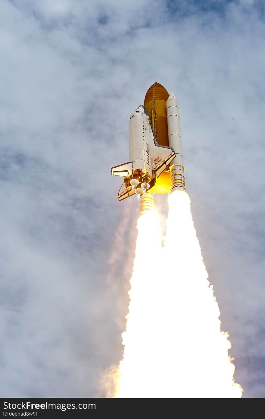 Launch of US Space Shuttle against blue skies and clouds. Launch of US Space Shuttle against blue skies and clouds.