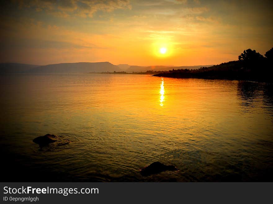 A lake landscape with an orange sunset. A lake landscape with an orange sunset.