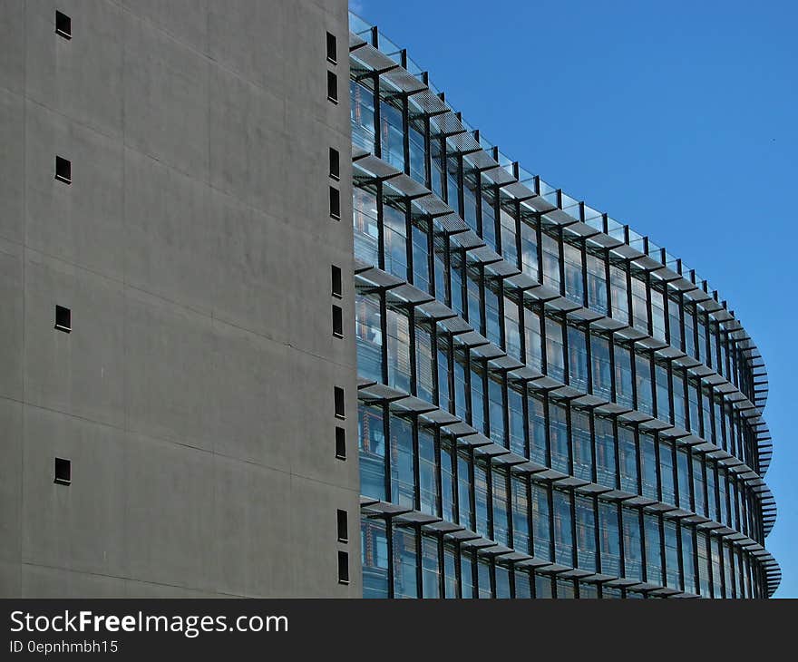 Grey Concrete Building With Blue Windows