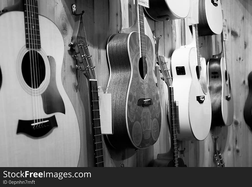 Gray Scale Photo of Acoustic Guitars