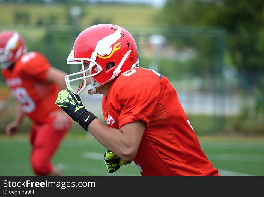 Portrait of football player in game wearing helmet and uniform.