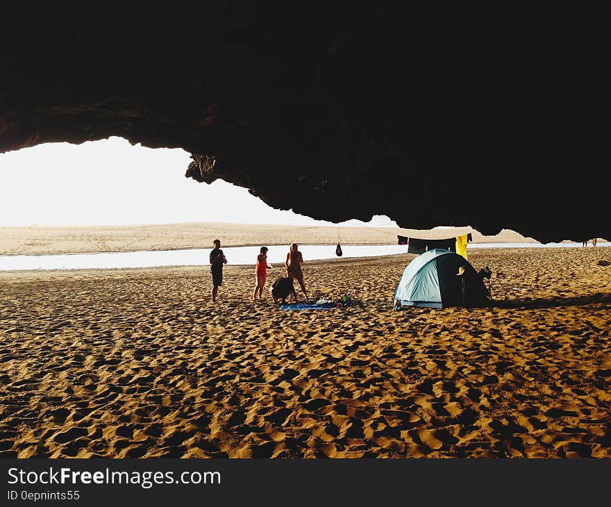 People on Beach by Blue Tent