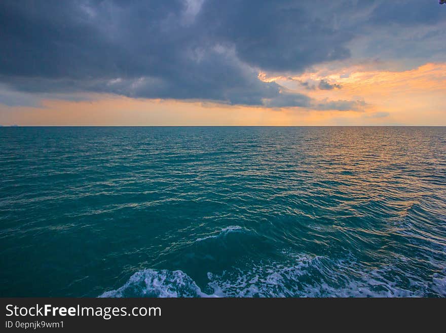 Sunset in blue skies over ocean waves. Sunset in blue skies over ocean waves.