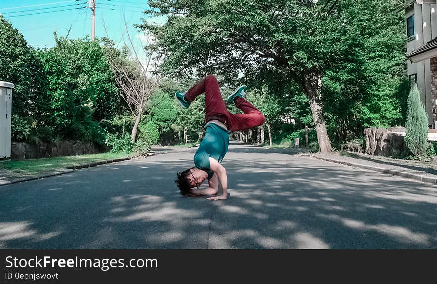 Asian man break-dancing on sunny streets. Asian man break-dancing on sunny streets.