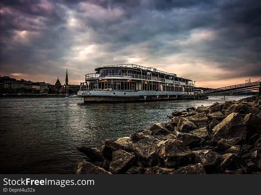 White Ferry Boat by Rocky Shore