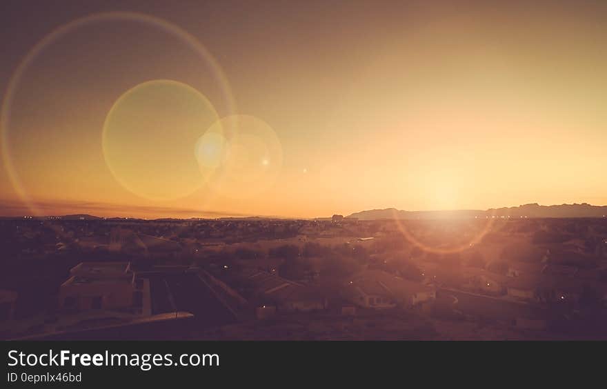 Flares in sunset skies over country field. Flares in sunset skies over country field.