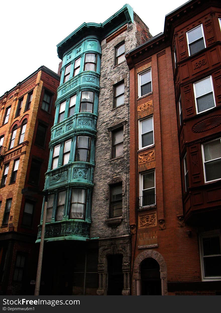 Colorful exterior of brick row houses against overcast skies. Colorful exterior of brick row houses against overcast skies.