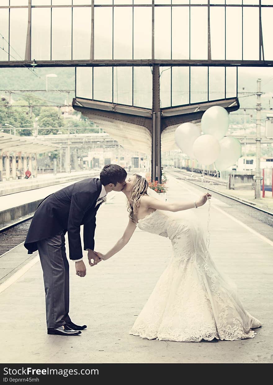 Couple Kissing Standing on the Train Waiting Platform