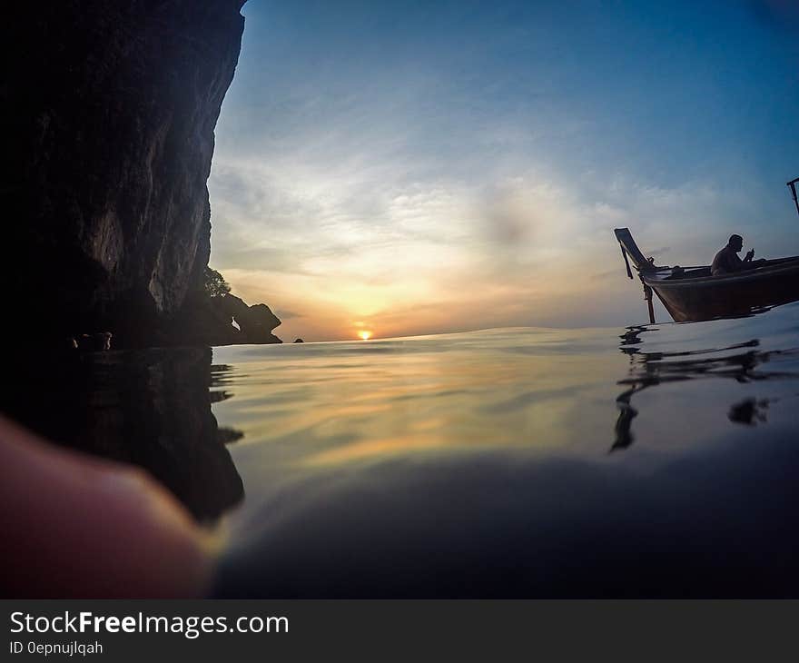 Silhouette of Man Riding Boat