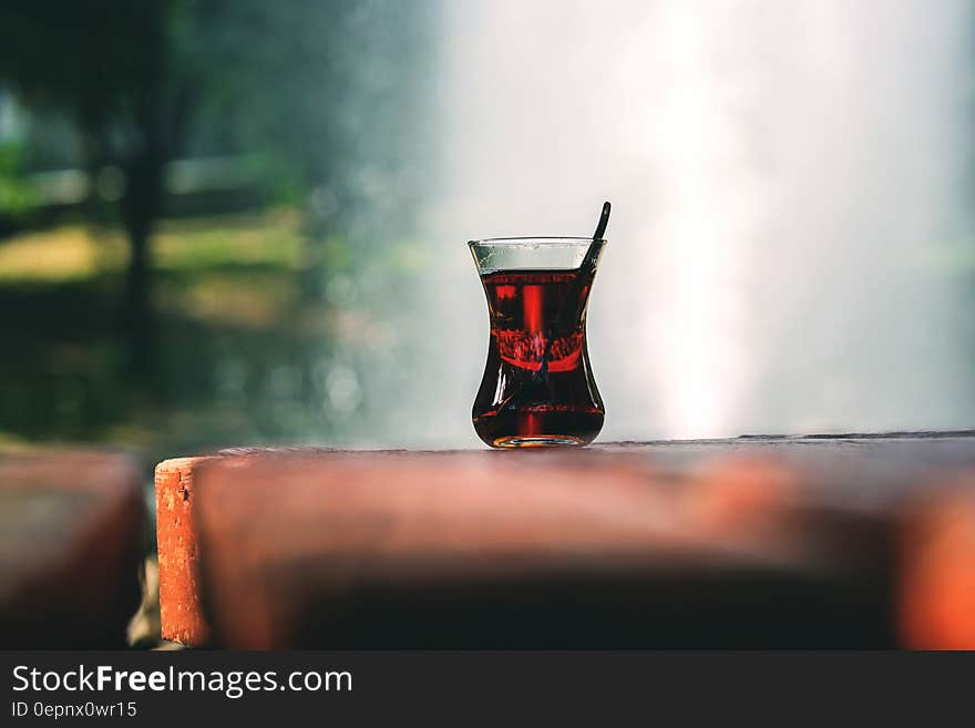 Clear Turkey Tea Glass With Tea on Brown Wooden Table