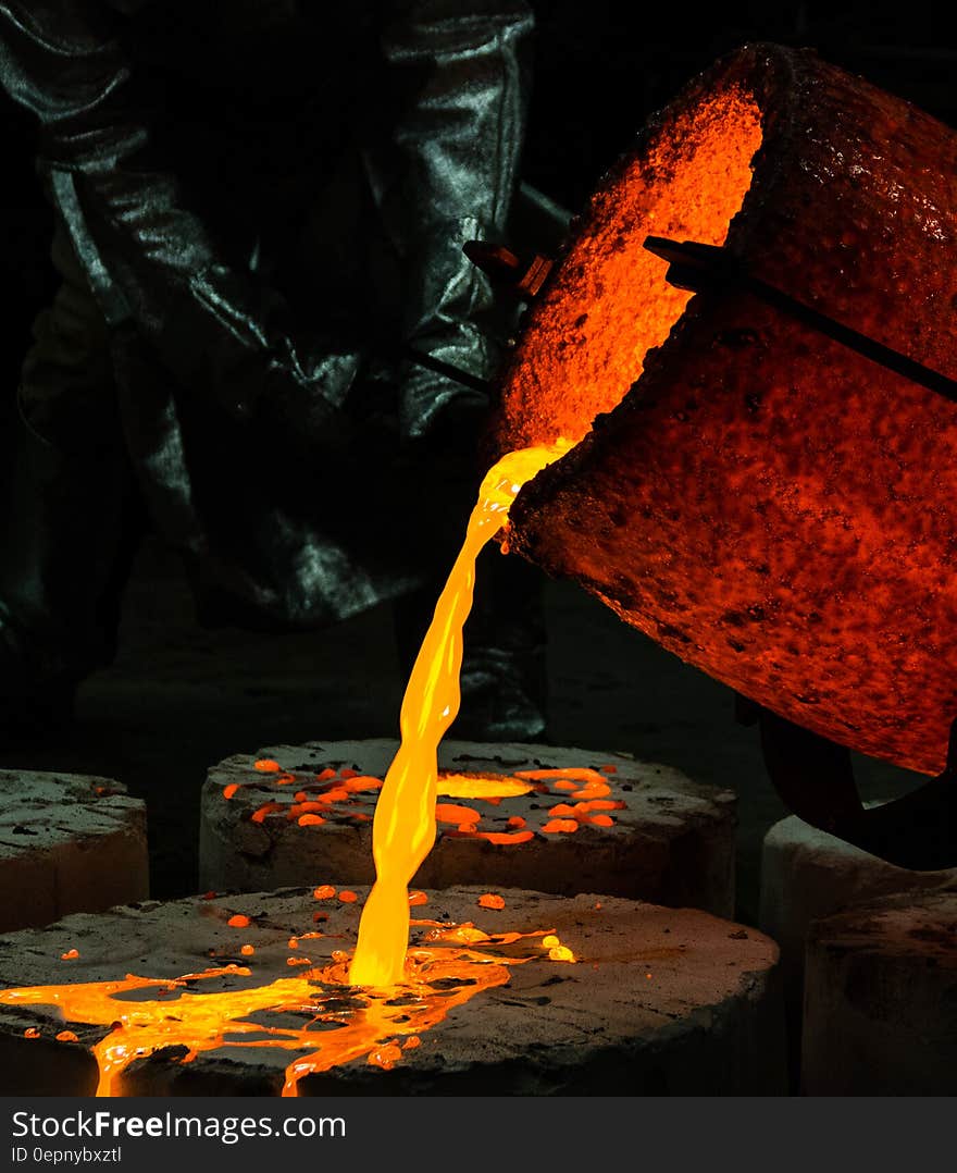 Yellow Container Pouring Yellow Liquid on Brown Wooden Round Textile