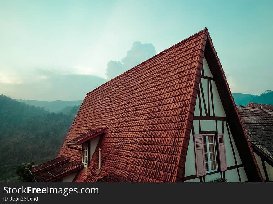 A tiled roof of a rustic style house. A tiled roof of a rustic style house.