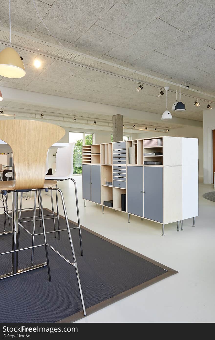 Table and bookshelves inside modern apartment. Table and bookshelves inside modern apartment.