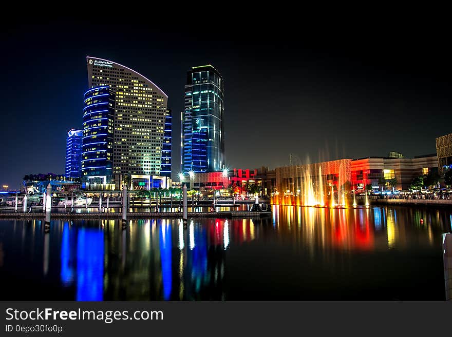 City Skyline Beside Water during Night