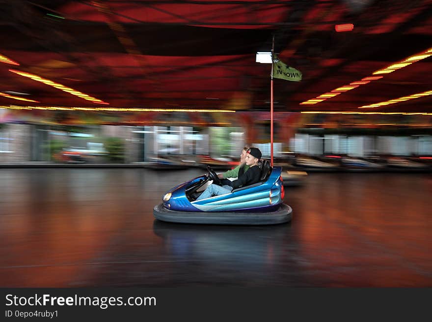 Riders in arcade bumper car. Riders in arcade bumper car.