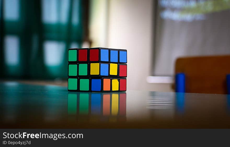 Close up of unsolved Rubik's cube on tabletop. Close up of unsolved Rubik's cube on tabletop.