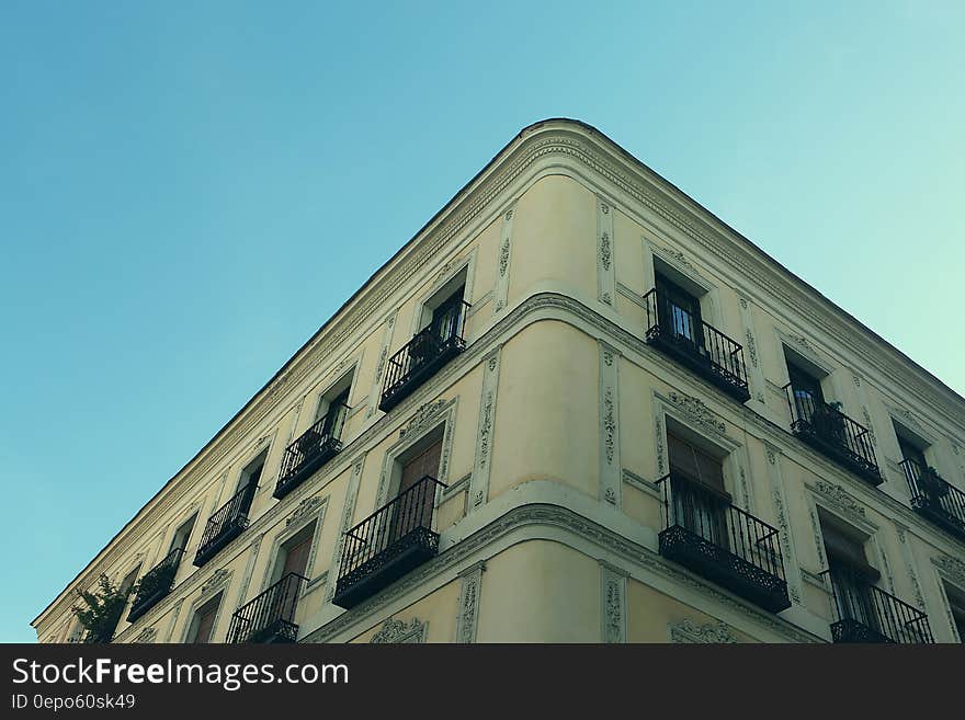 Corner of apartment building with balconies against blue skies on sunny day. Corner of apartment building with balconies against blue skies on sunny day.