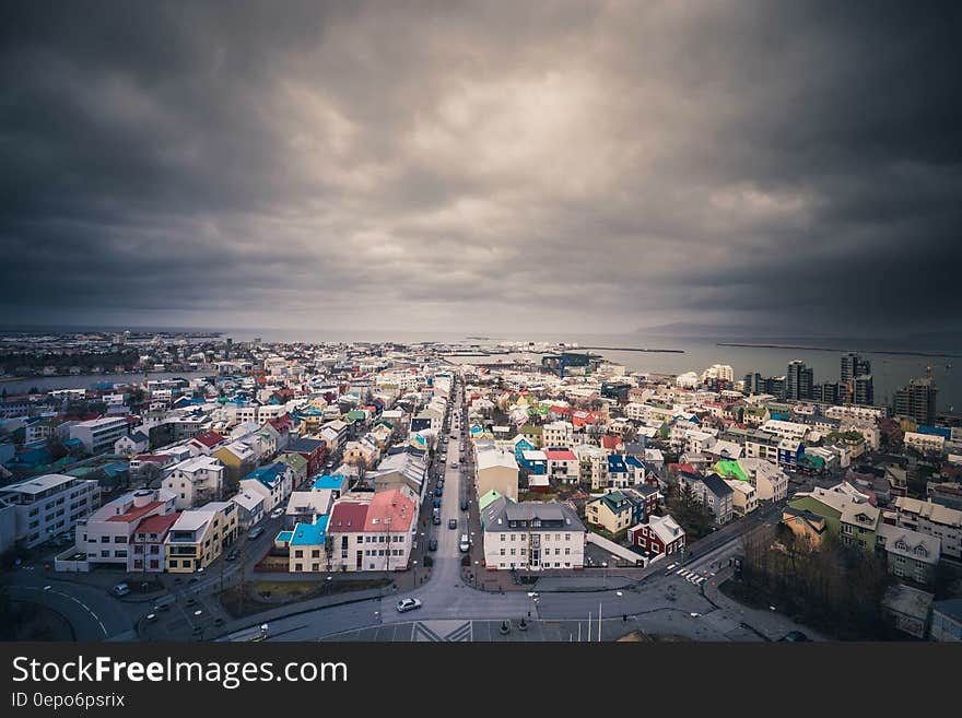 Aerial view over roof tops of Iceland waterfront village with stormy grey skies. Aerial view over roof tops of Iceland waterfront village with stormy grey skies.