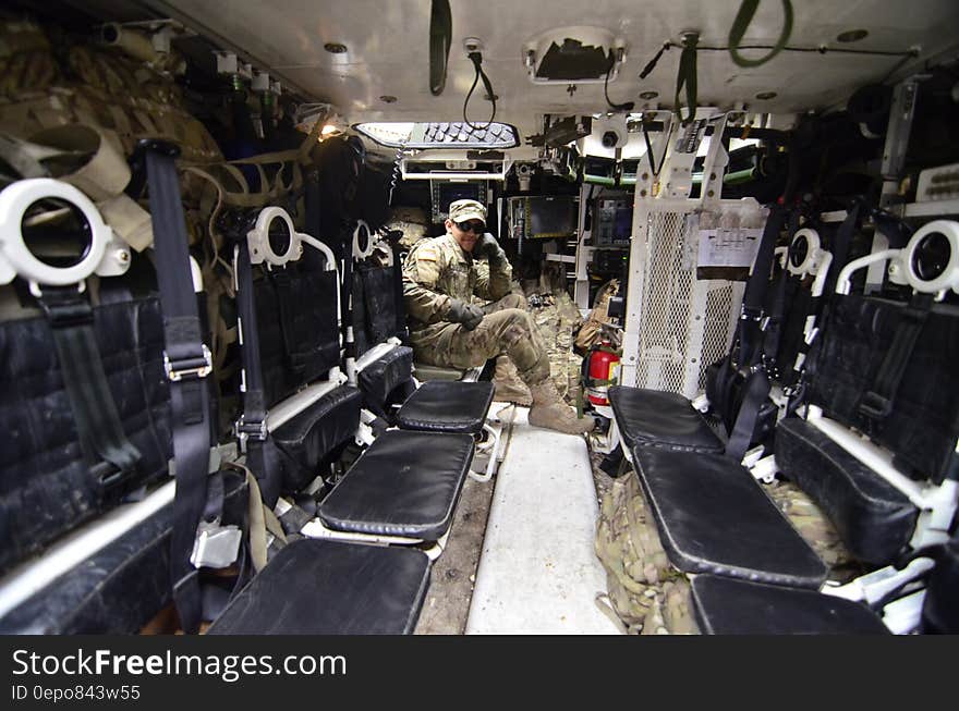 Man in Soldier Suit Sitting in Black Leather Seat