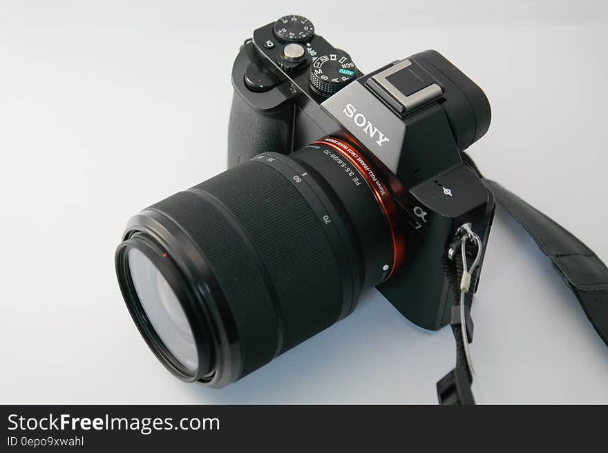 Black Sony Dslr Camera on White Surface