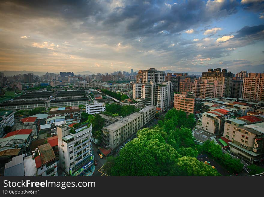 White Concrete City Buildings Under White Blue Sky at Daytime