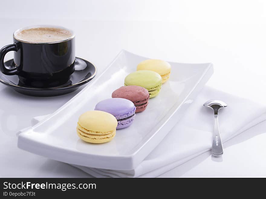 Black Teacup and 5 French Macaroons on Plate