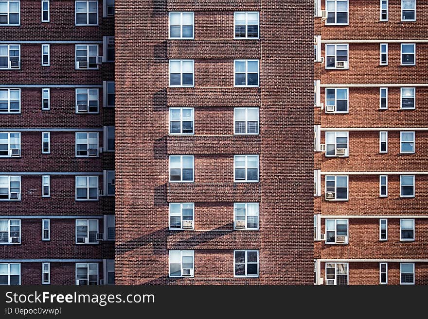 Simple high rise building facade with many windows.