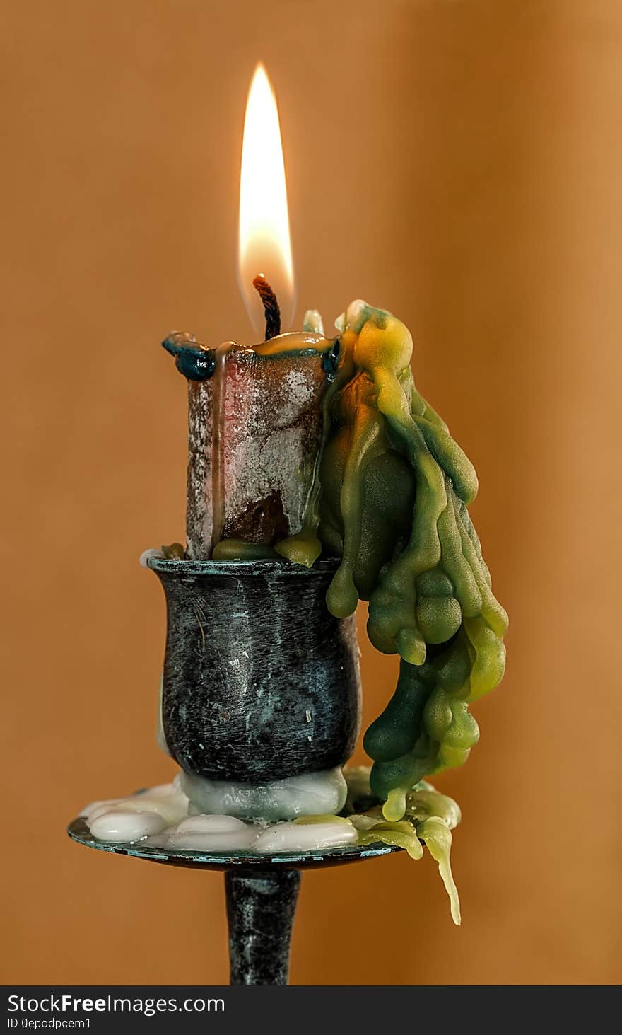 Close up of wick burning in wax candle on candlestick. Close up of wick burning in wax candle on candlestick.