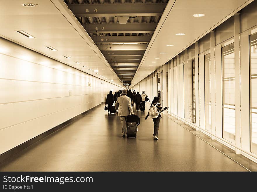 People Walking in the Hallway Inside the Building