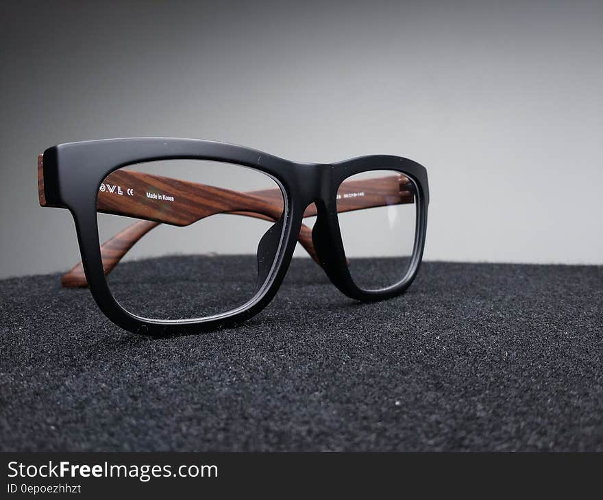 A pair of stylish eyeglasses on gray background. A pair of stylish eyeglasses on gray background.