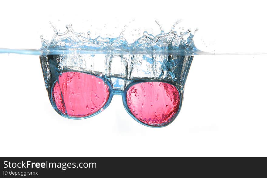 Black Framed Red Aviator Sunglasses on Water