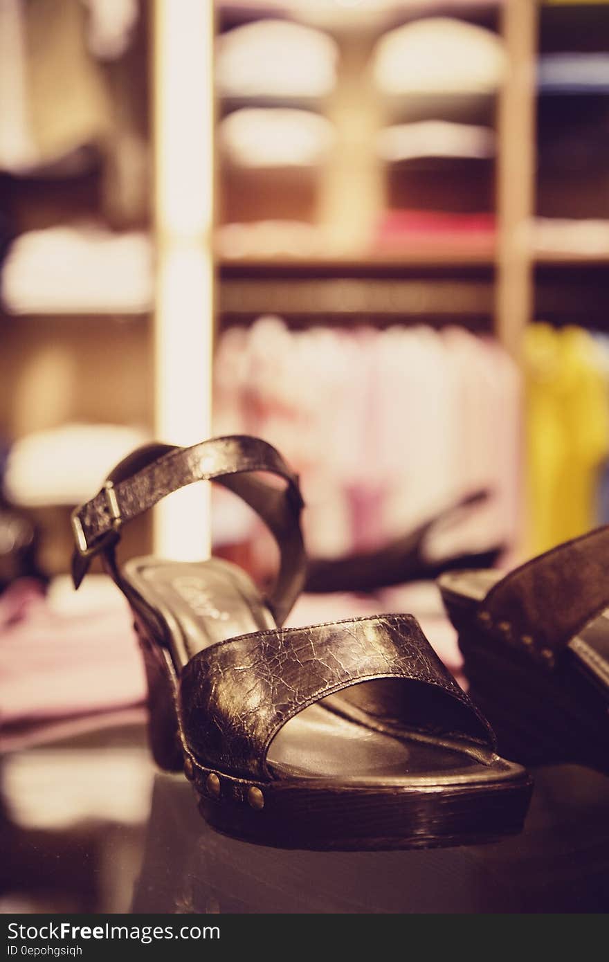 Pair of Brown Leather Sandals on Wooden Slab