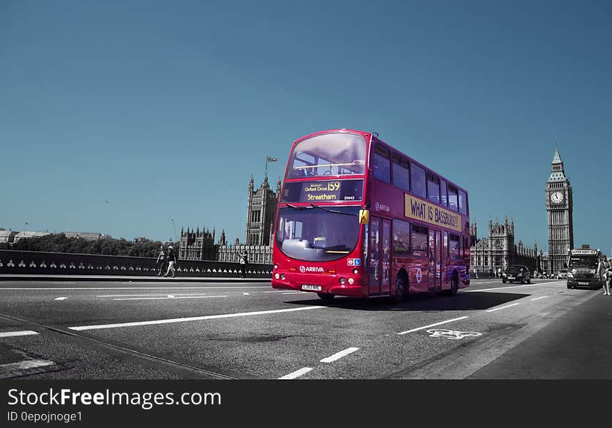 Double decker bus on roadway outside Parliament Building with Big Ben clock tower in London, England. Double decker bus on roadway outside Parliament Building with Big Ben clock tower in London, England.