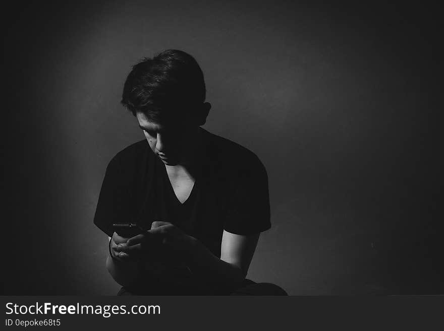 Portrait of man using smartphone in black and white studio portrait. Portrait of man using smartphone in black and white studio portrait.