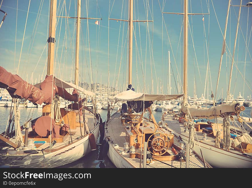 Docked boats in a harbour, on a sunny day.