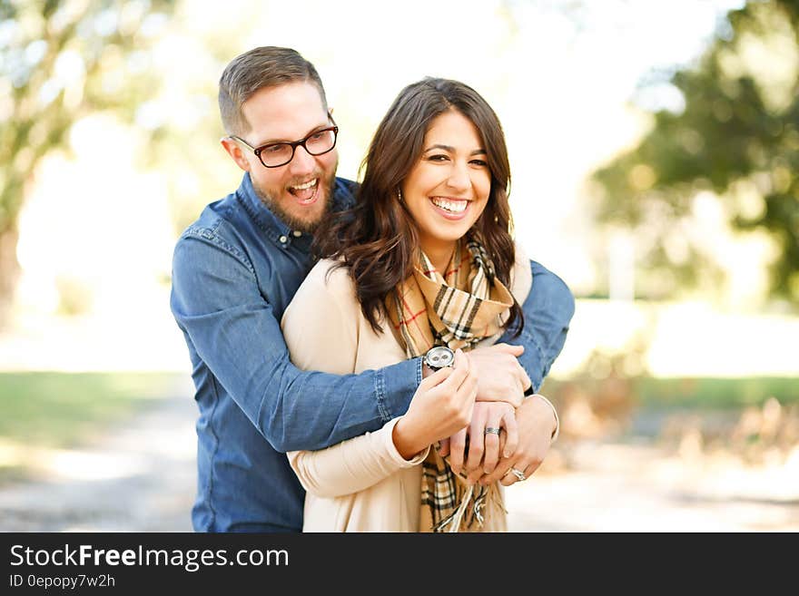 Portrait of Happy Young Woman Using Mobile Phone in City