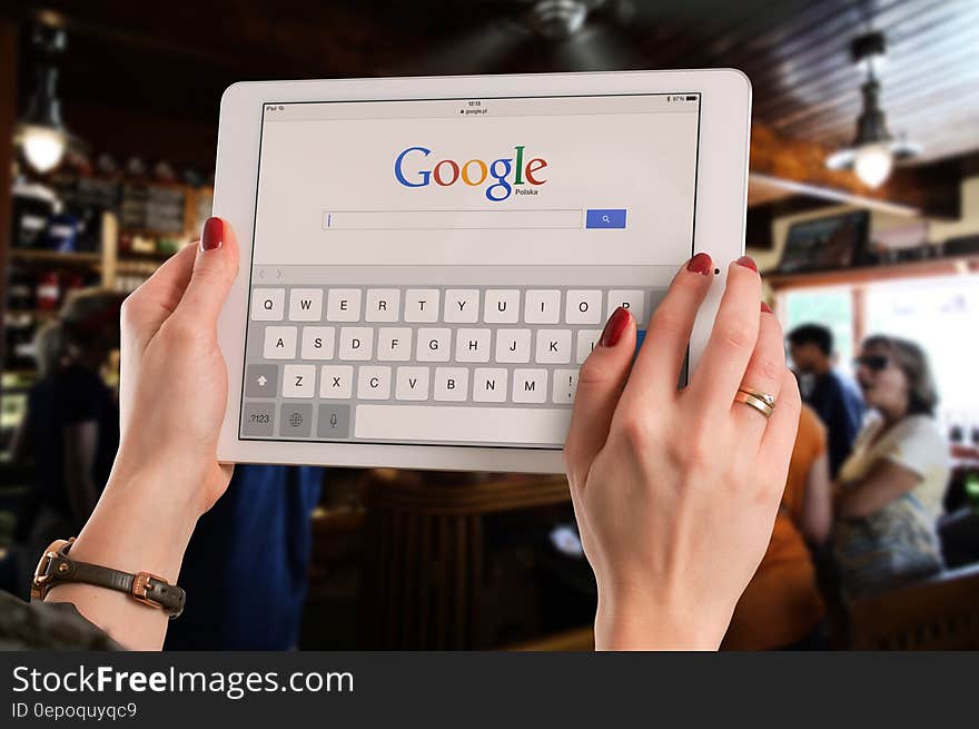 Person Holding White Ipad