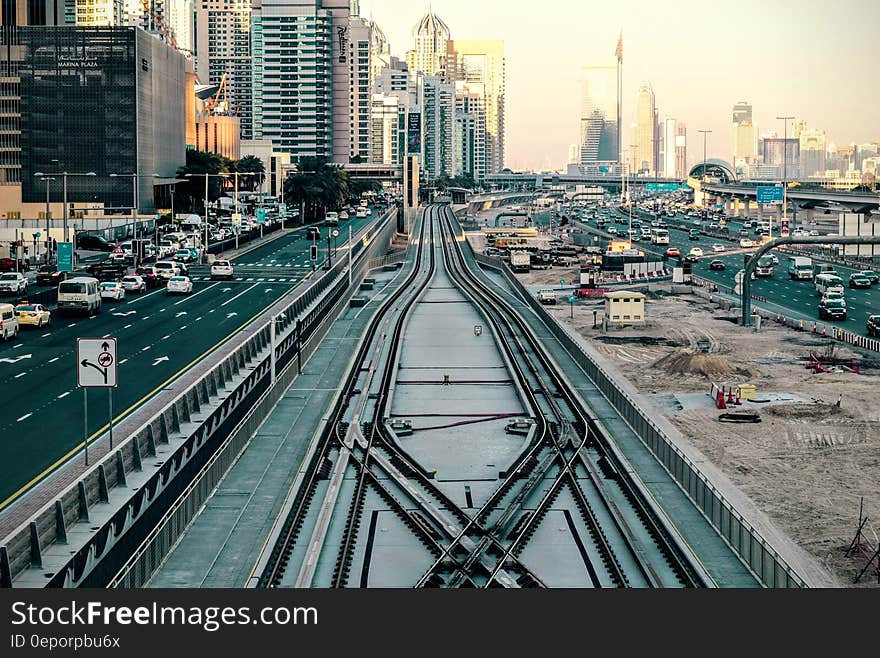 Traffic on roadway with public transportation track in Dubai, UAE on sunny day. Traffic on roadway with public transportation track in Dubai, UAE on sunny day.