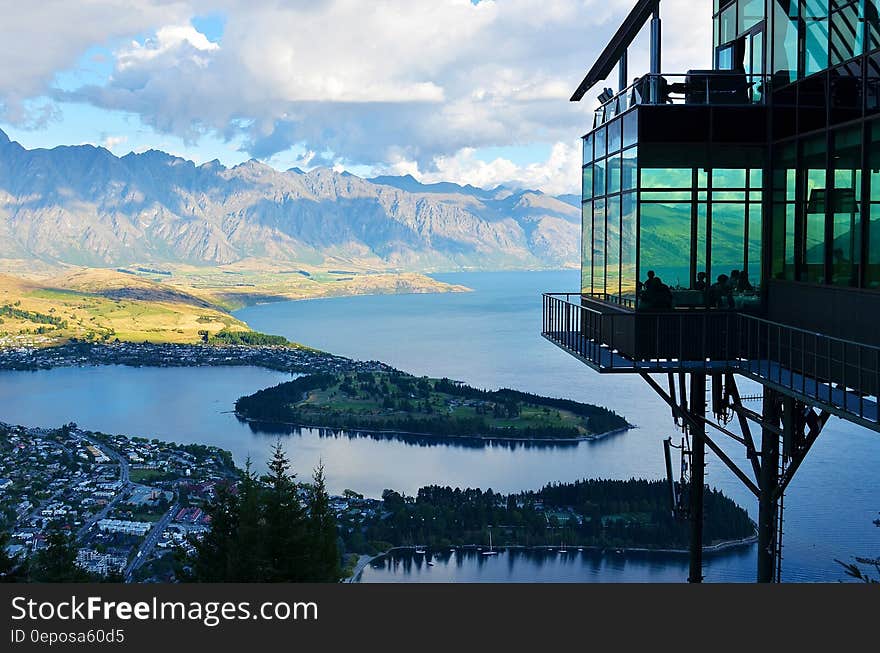 Inspired architecture of a restaurant constructed mainly of glass and metal with magnificent views over forest and lake and distant mountains. Inspired architecture of a restaurant constructed mainly of glass and metal with magnificent views over forest and lake and distant mountains.