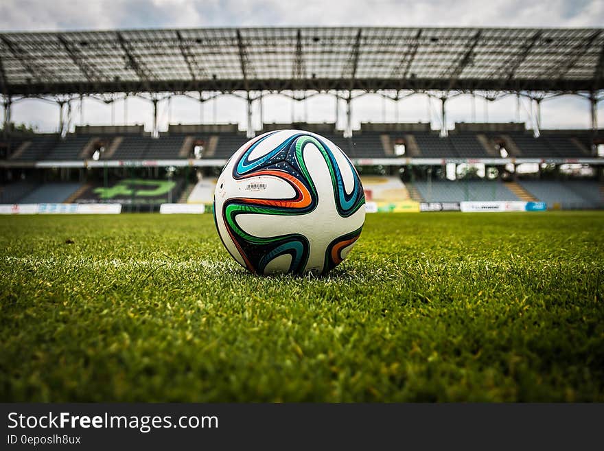 White Black and Green Soccer Ball on Soccer Field