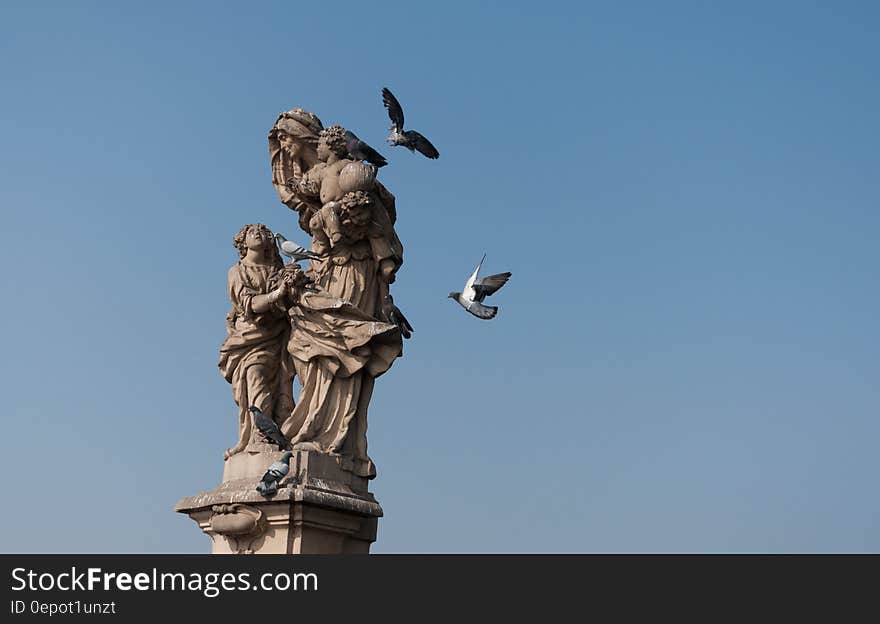 Woman Carrying Child Statue