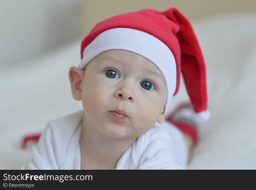 Portrait of young baby wearing red Santa stocking cap. Portrait of young baby wearing red Santa stocking cap.