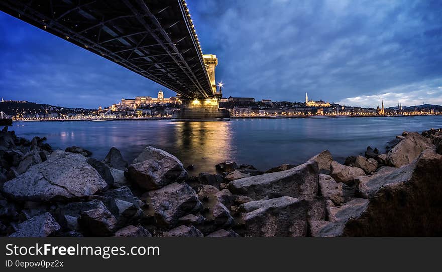 View of Rocky Shore Under Bridge