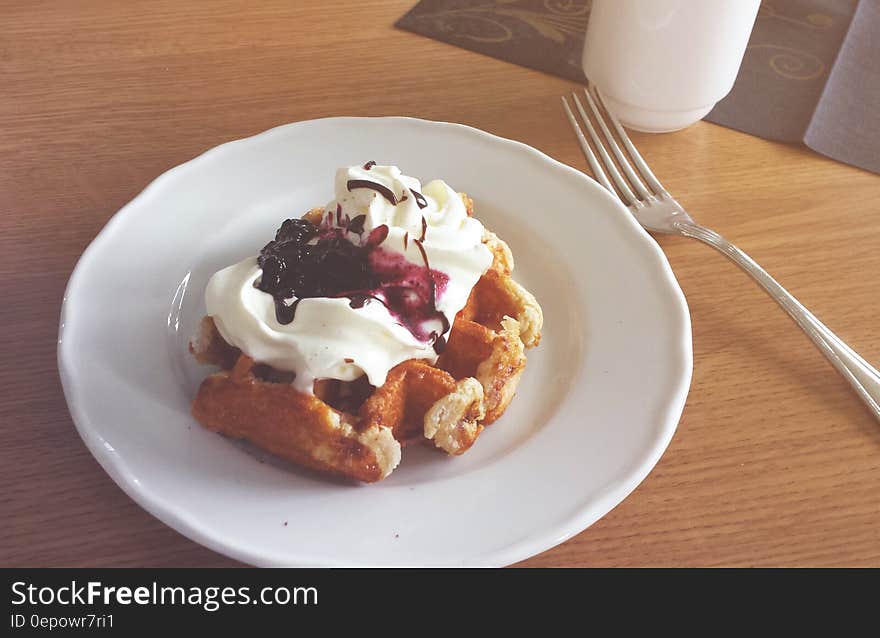 White Ceramic Plate Beside Stainless Steel Dining Fork